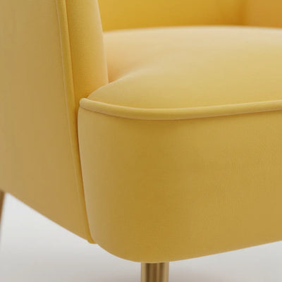 Close-up of a yellow armchair with a blurred background
